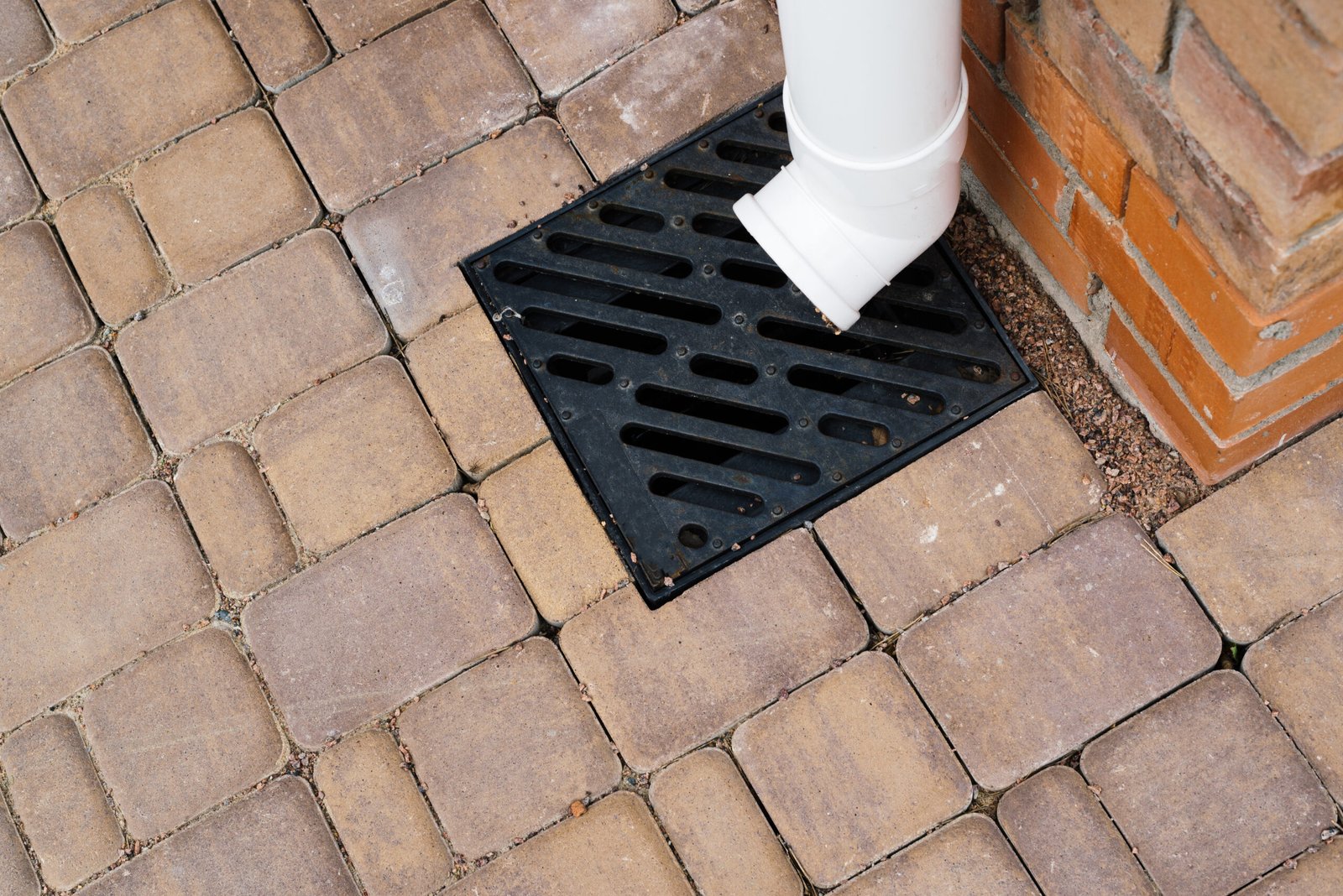 Stormwater cast iron drainage system in a pavement. Is used for drainage and separation of water from footpath. High quality photo